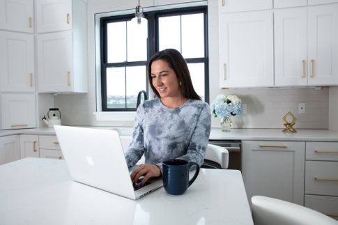 Woman using ServiceLink's EXOS closing cd on her home computer 